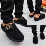 A stylish pair of grey half shoes with a gold buckle and black sole, perfect for adding a touch of luxury to any outfit.