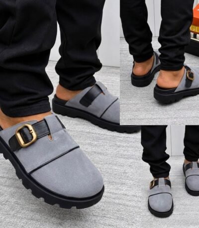 A stylish pair of grey half shoes with a gold buckle and black sole, perfect for adding a touch of luxury to any outfit.