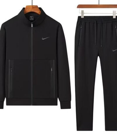 A luxurious Nike tracksuit comprising a zip-up jacket and matching joggers, both in dark grey with black accents, exuding sophistication and high-end athletic wear.