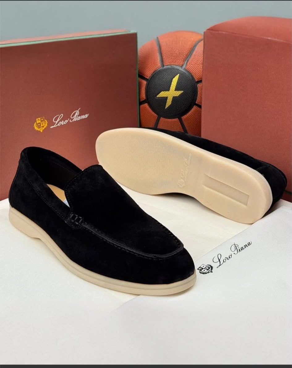 WhatsApp Image 2026-10-13 at 9.54.1kk6 AM A pair of luxurious black velvet loafers from Loro Piana, showcased with their box and packaging, exuding high-end quality and sophistication.